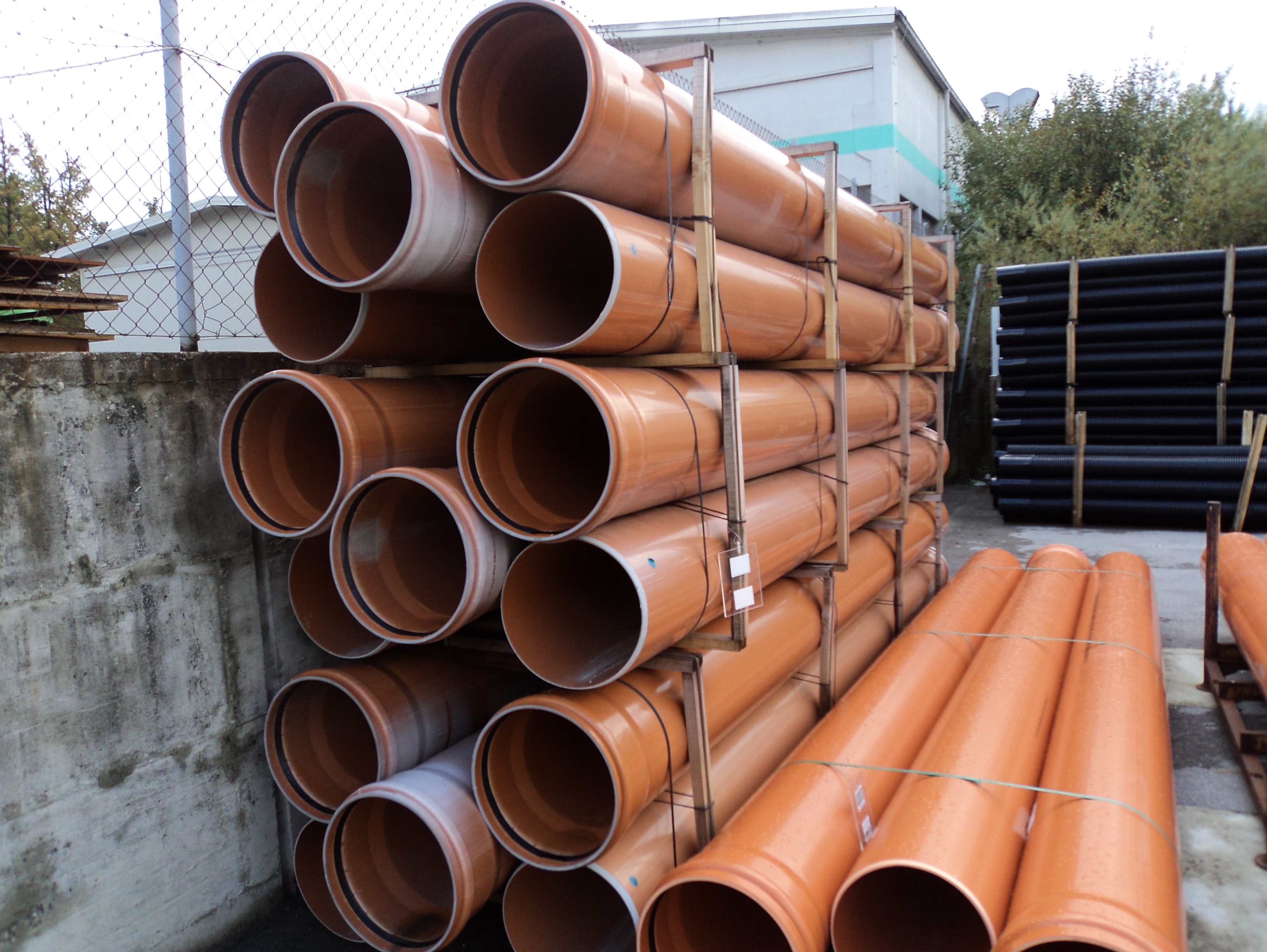 A stack of reddish plastic pipes.
