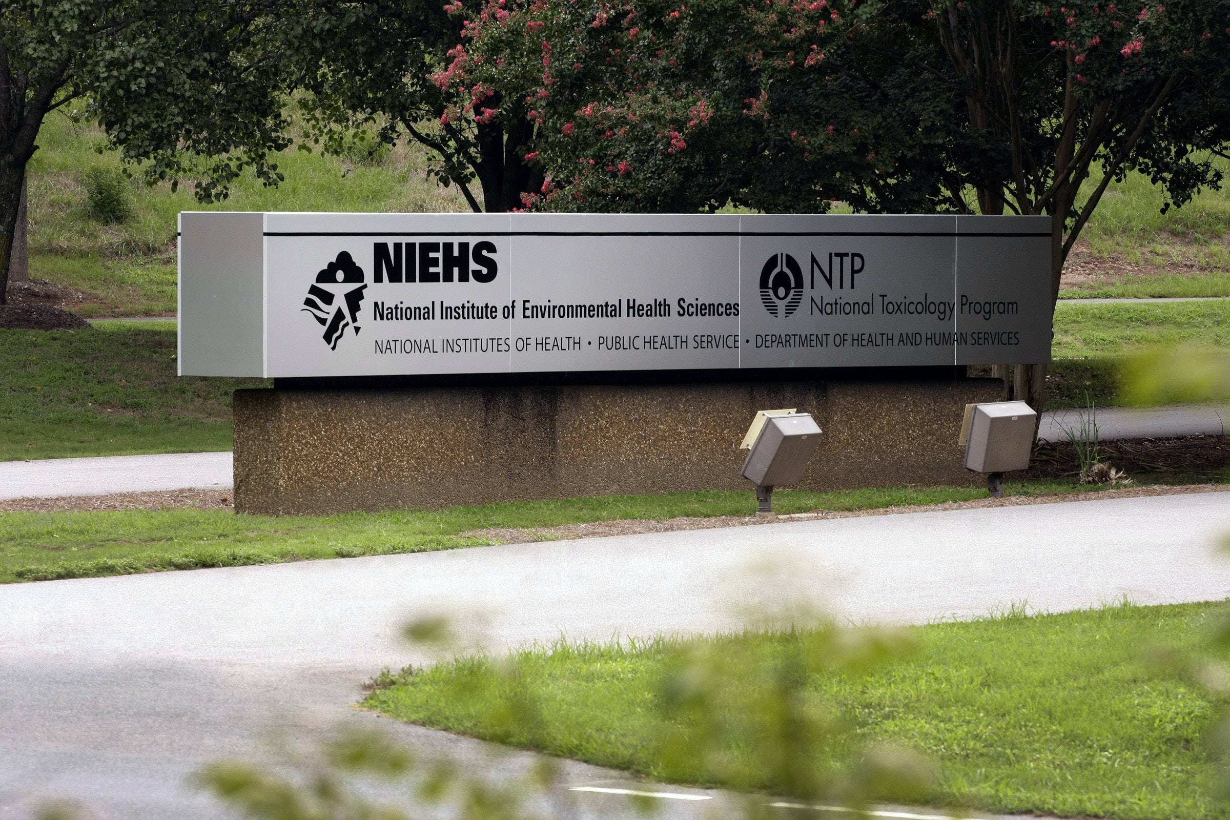 A silver sign showing the National Institute of Environmental Health Sciences and the National Toxicology Program