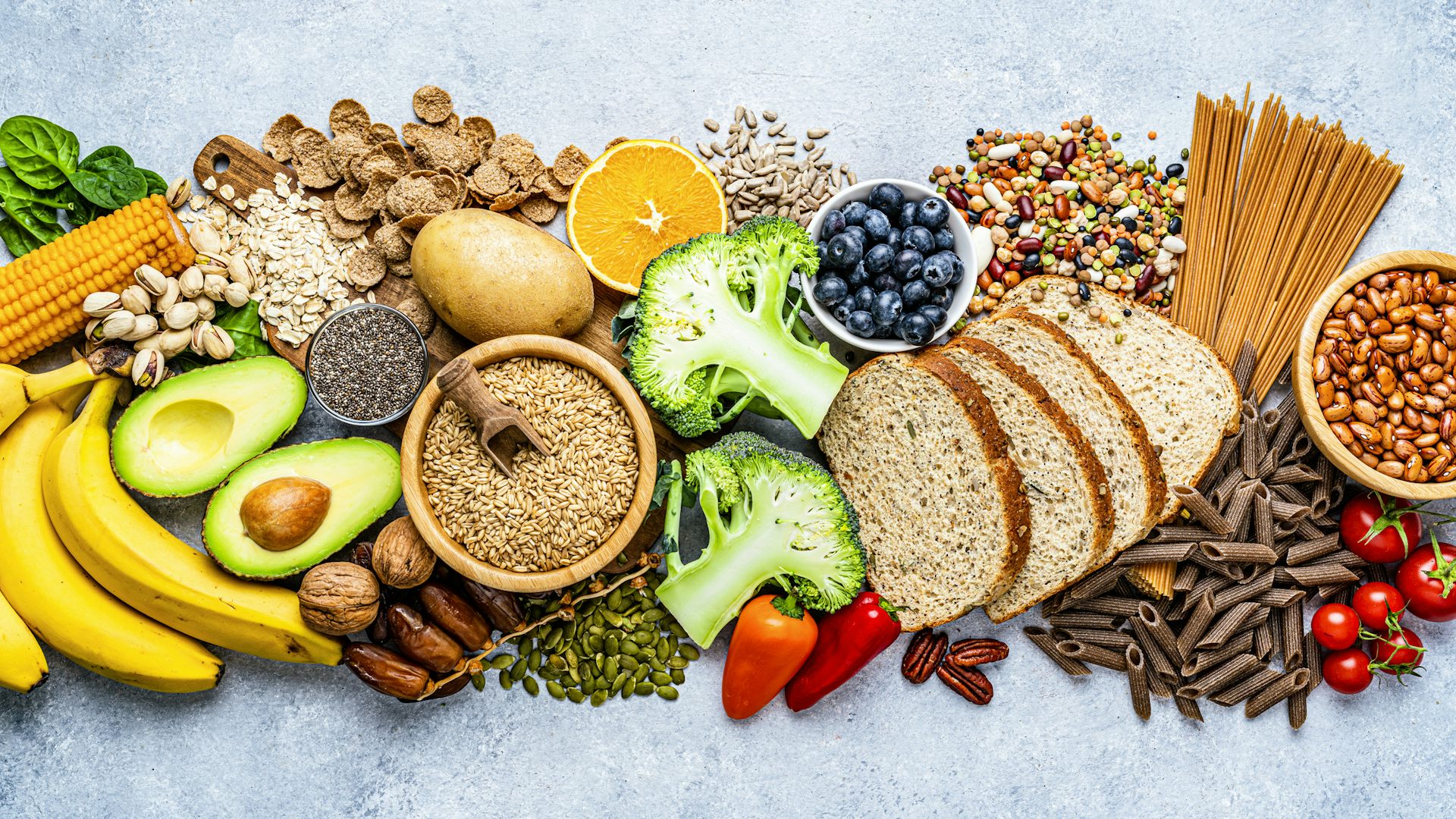 Overhead view of colorful foods with high dietary fiber content arranged side by side on a countertop.